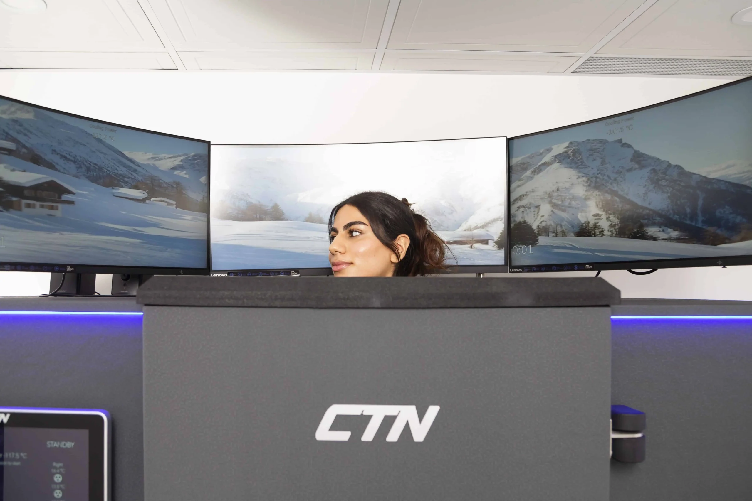Front desk receptionist greeting clients at modern medical spa counter