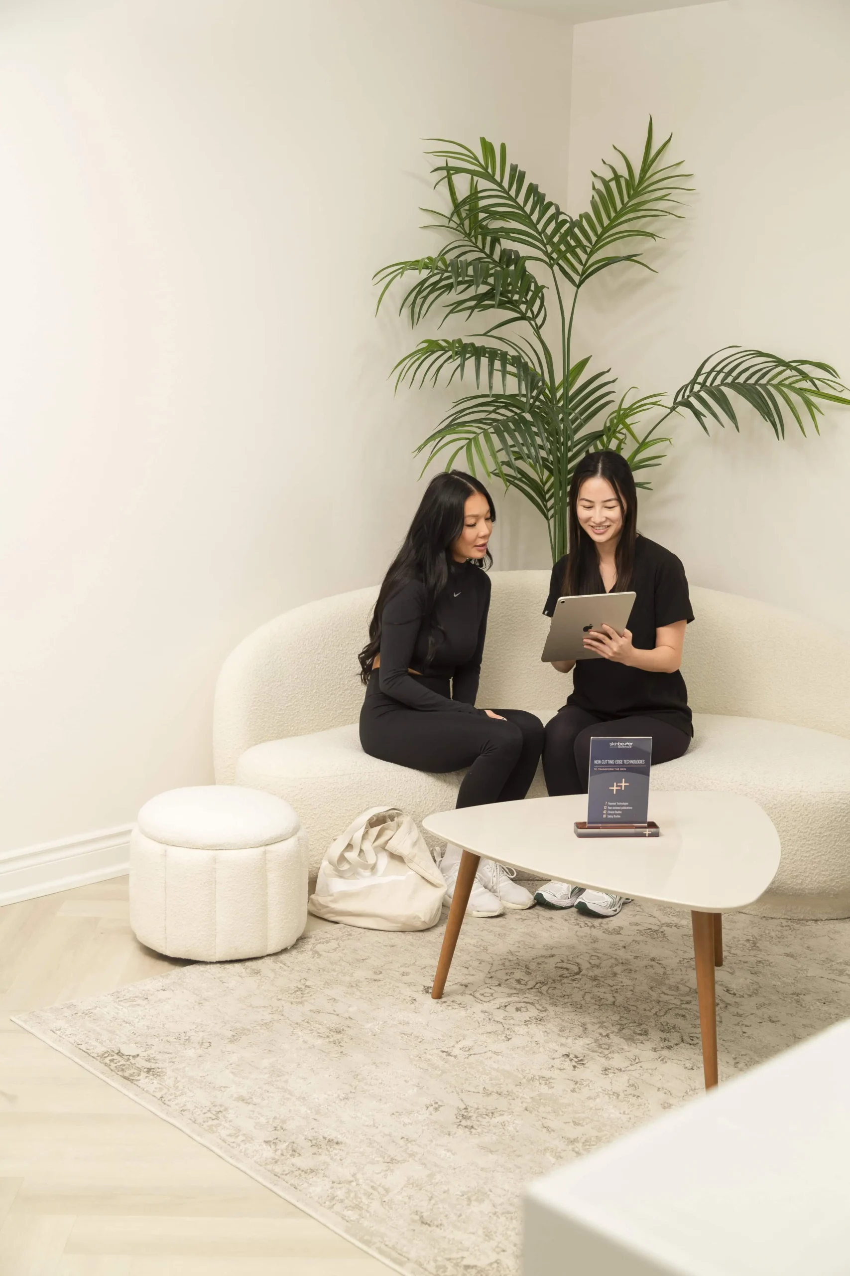 Two women reviewing treatment options during spa consultation