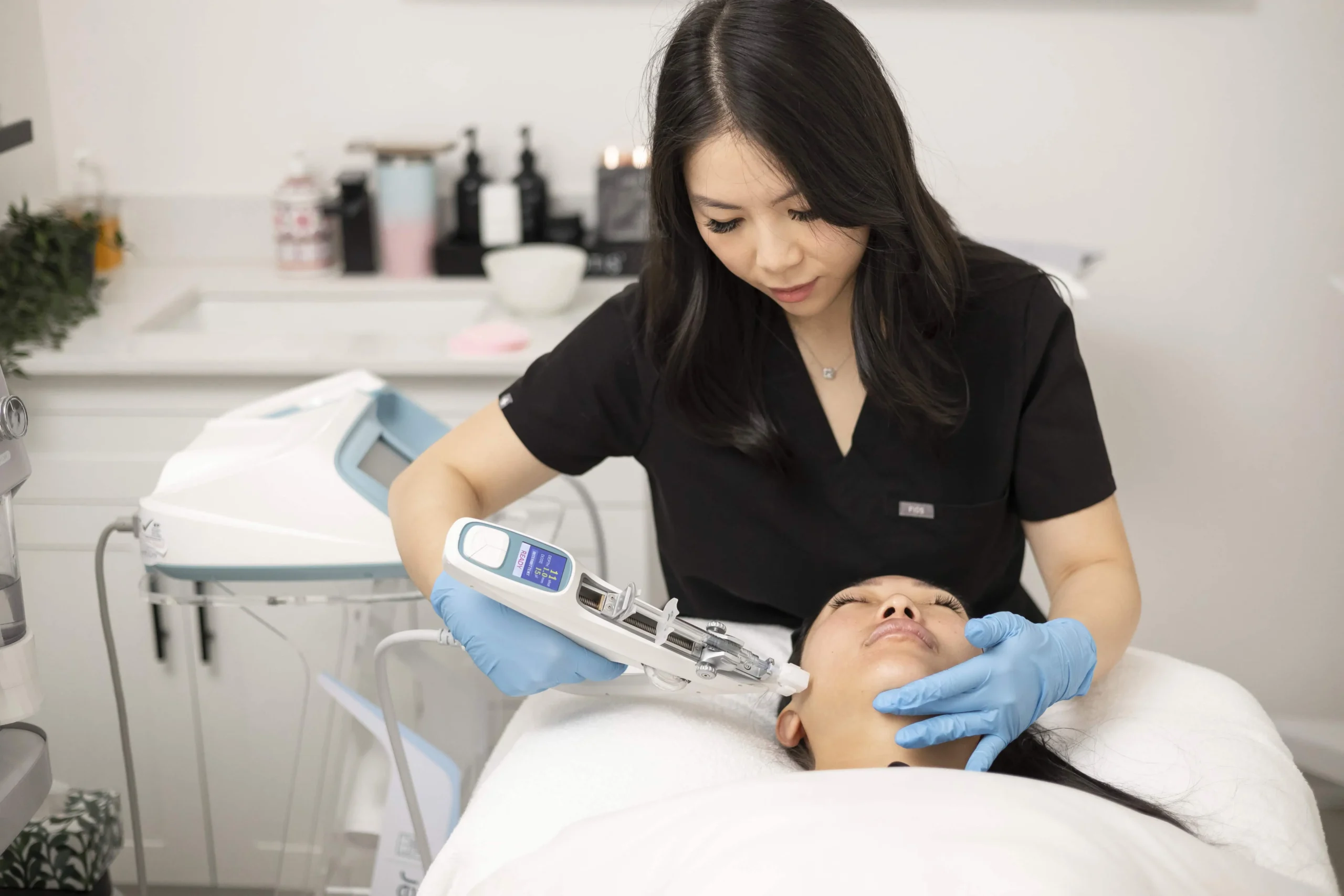 Practitioner combining hydrafacial and light therapy skin rejuvenation