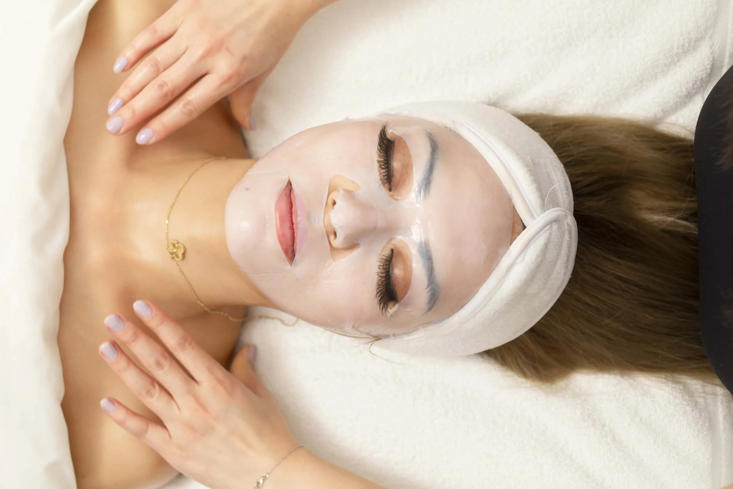 Patient enjoying brightening facial mask applied during spa treatment