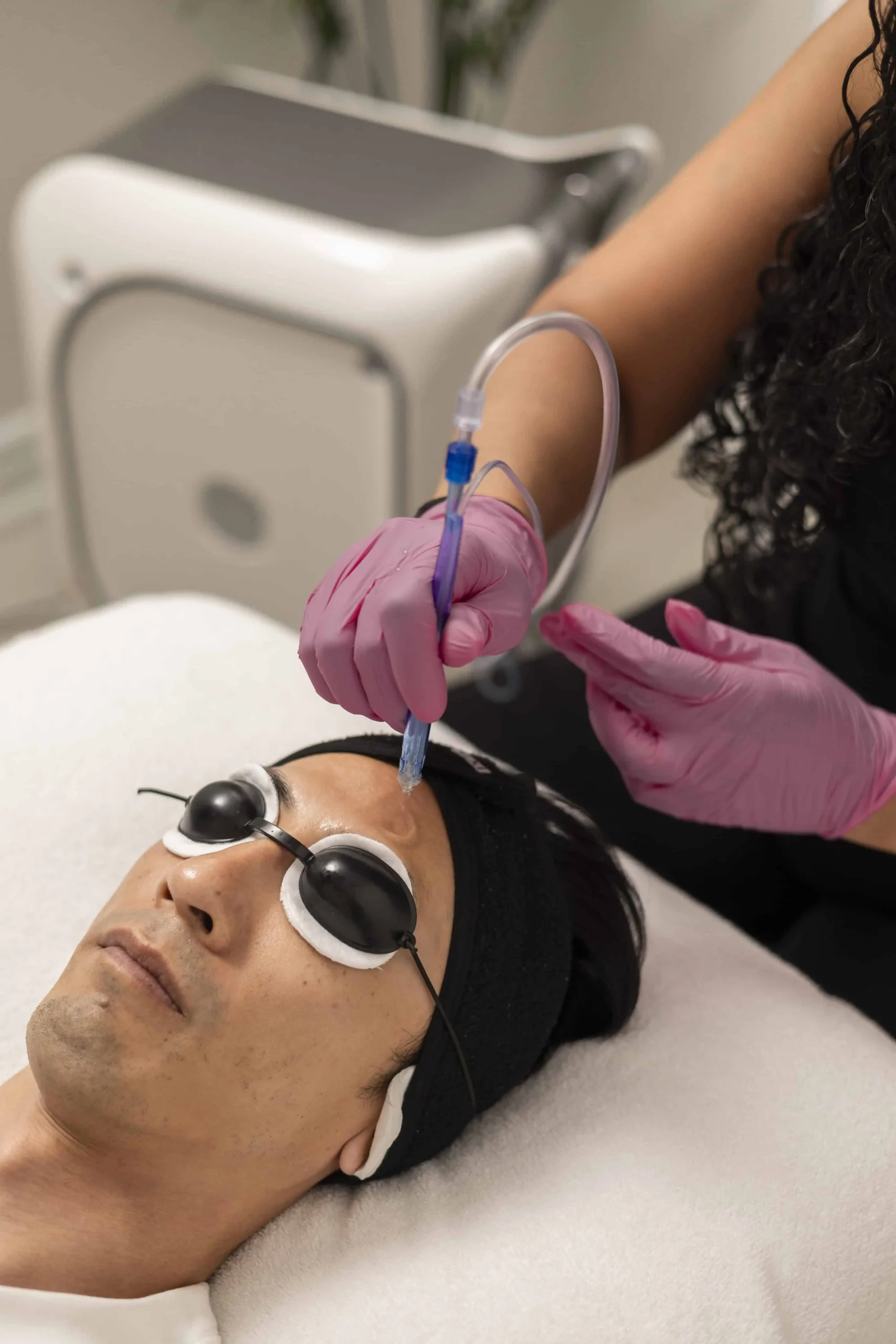 Pilates training session with man performing leg workout on reformer